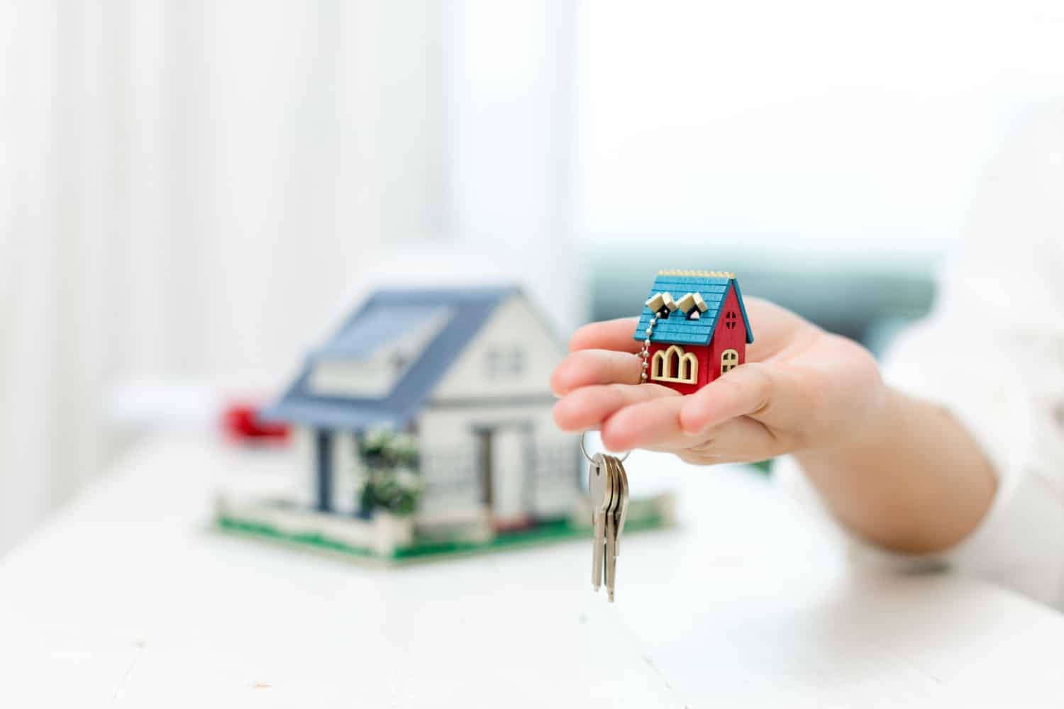 real-estate-agent-with-house-model-keys